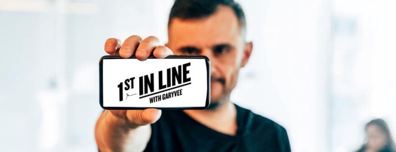 Gary Vaynerchuk holding up a smartphone to show the screen to the camera