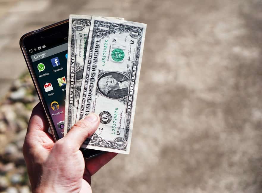 an android phone with 2 one dollar bills